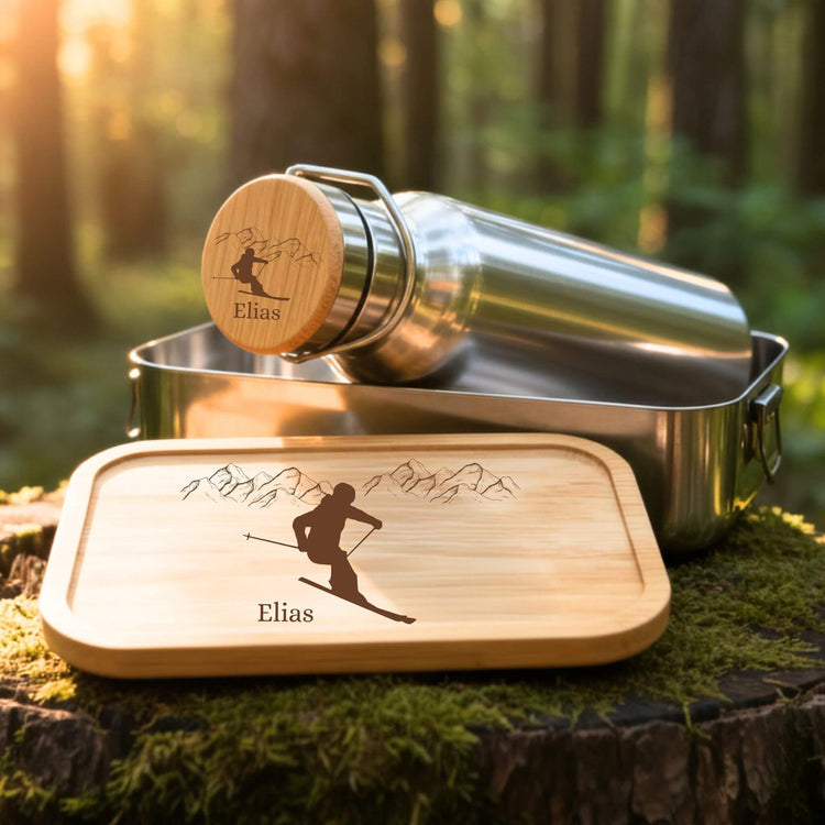 Personalisiertes Edelstahl Trinkflaschen- und Lunchbox-Set mit Skifahrer-Gravur und Namen Elias auf Bambusdeckel.