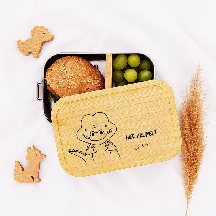 Personalisierte Edelstahl-Brotdose mit Bambusdeckel, graviertem Dinosaurier-Motiv und Name fuer Kinder.