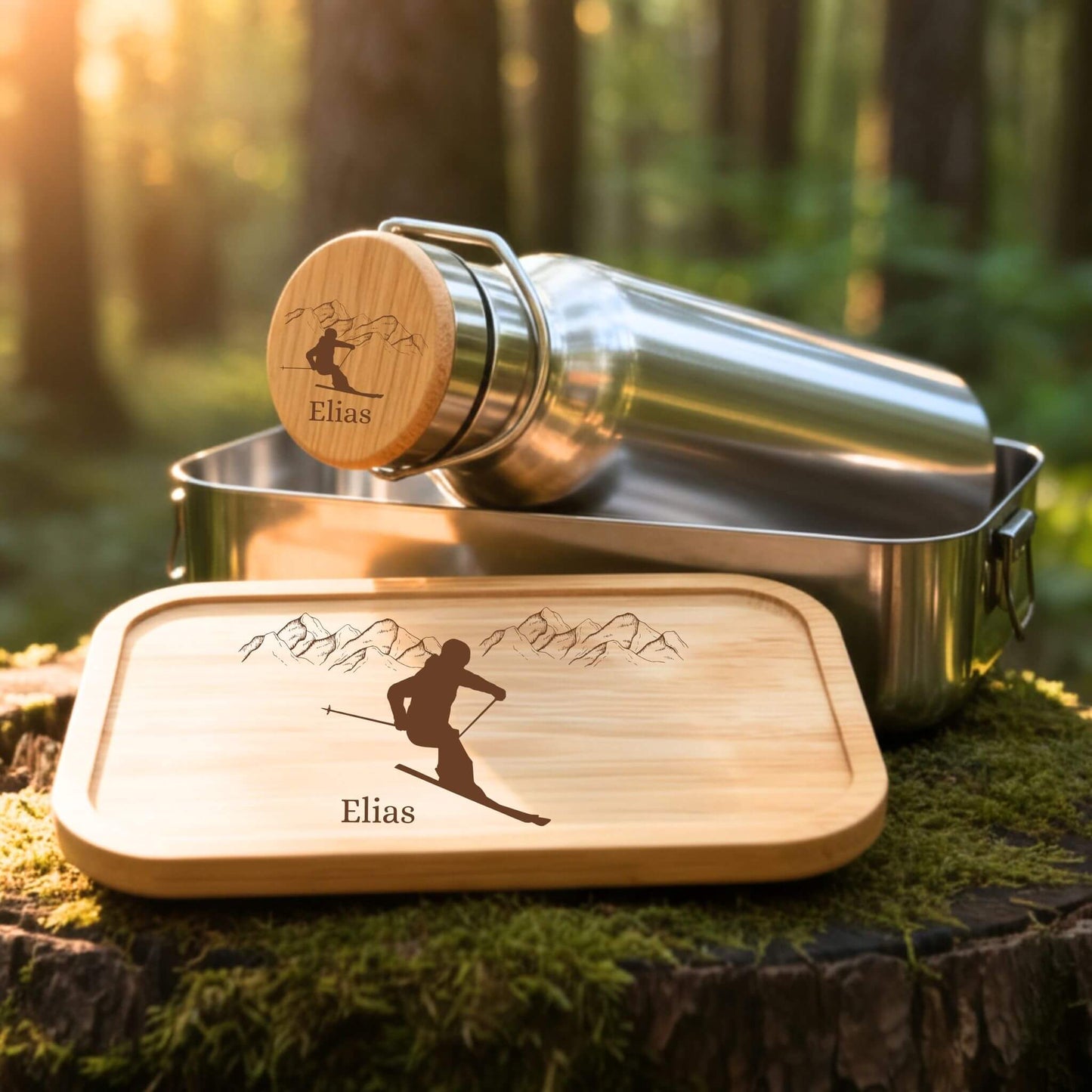 Personalisiertes Edelstahl Trinkflaschen- und Lunchbox-Set mit Skifahrer-Gravur und Namen Elias auf Bambusdeckel.