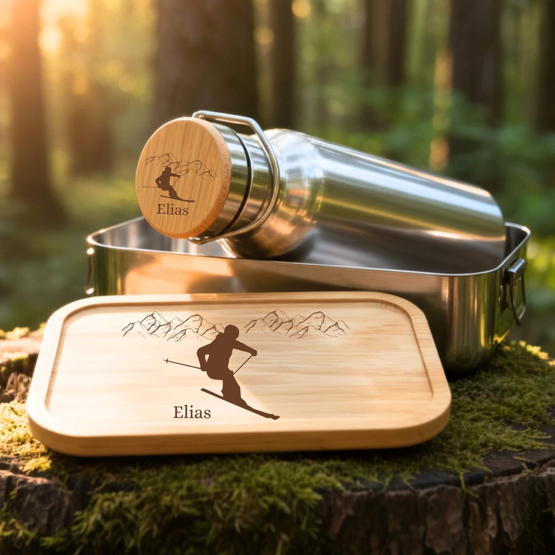 Personalisiertes Edelstahl Trinkflaschen- und Lunchbox-Set mit Skifahrer-Gravur und Namen Elias auf Bambusdeckel.