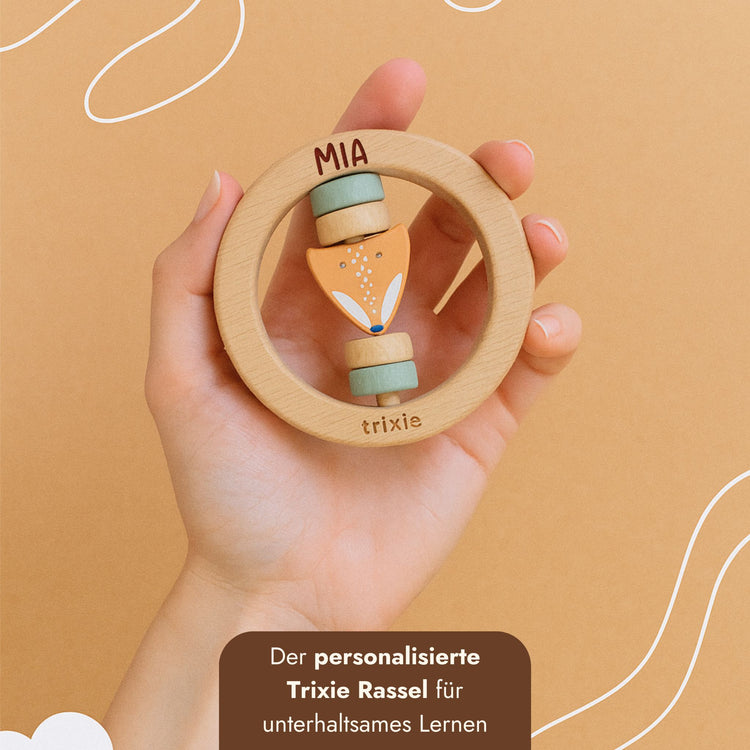 Personalisierter Holz-Greifling mit Fuchsfigur und Namensgravur in einer Kinderhand.