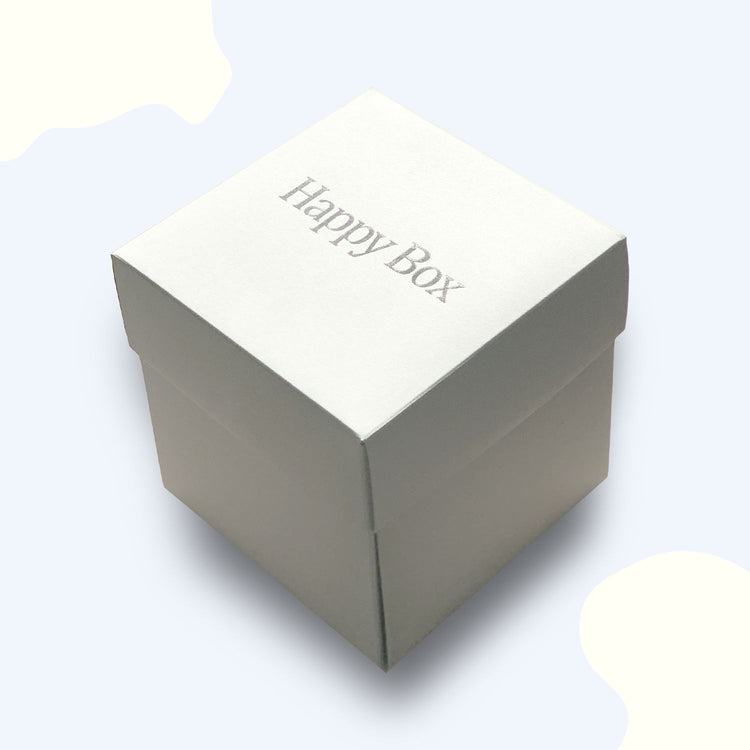 Weisse Happy Box Geschenkbox mit silberner Praegung auf dem Deckel, ideal als personalisierte Geschenkverpackung.