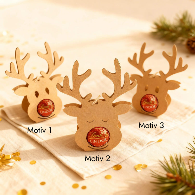 Drei Rentier-Schokoladenhalter aus Kraftpapier mit Lindor-Kugel als Nase in verschiedenen Motiven als Weihnachtsgeschenk.