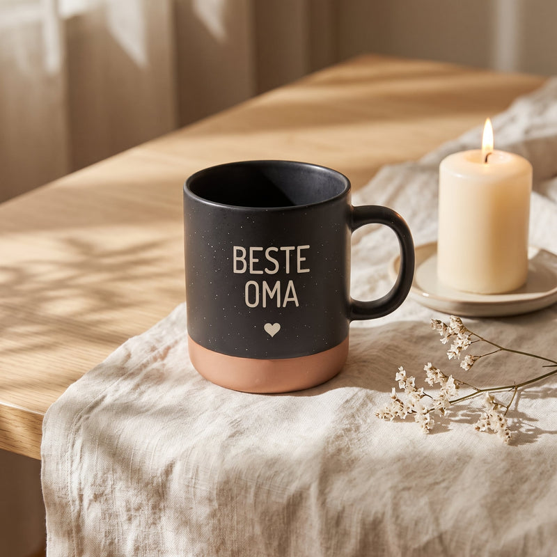 Keramik Tasse 360ml - Beste in schwarz: beste oma, auf Leinen mit Kerze und Trockenblumen.