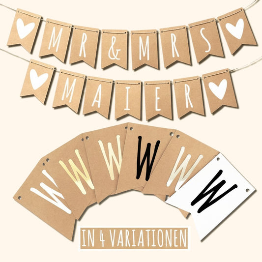Wimpelkette Hochzeit Mr & Mrs mit Namen aus Kraftpapier vor cremefarbenem Hintergrund.